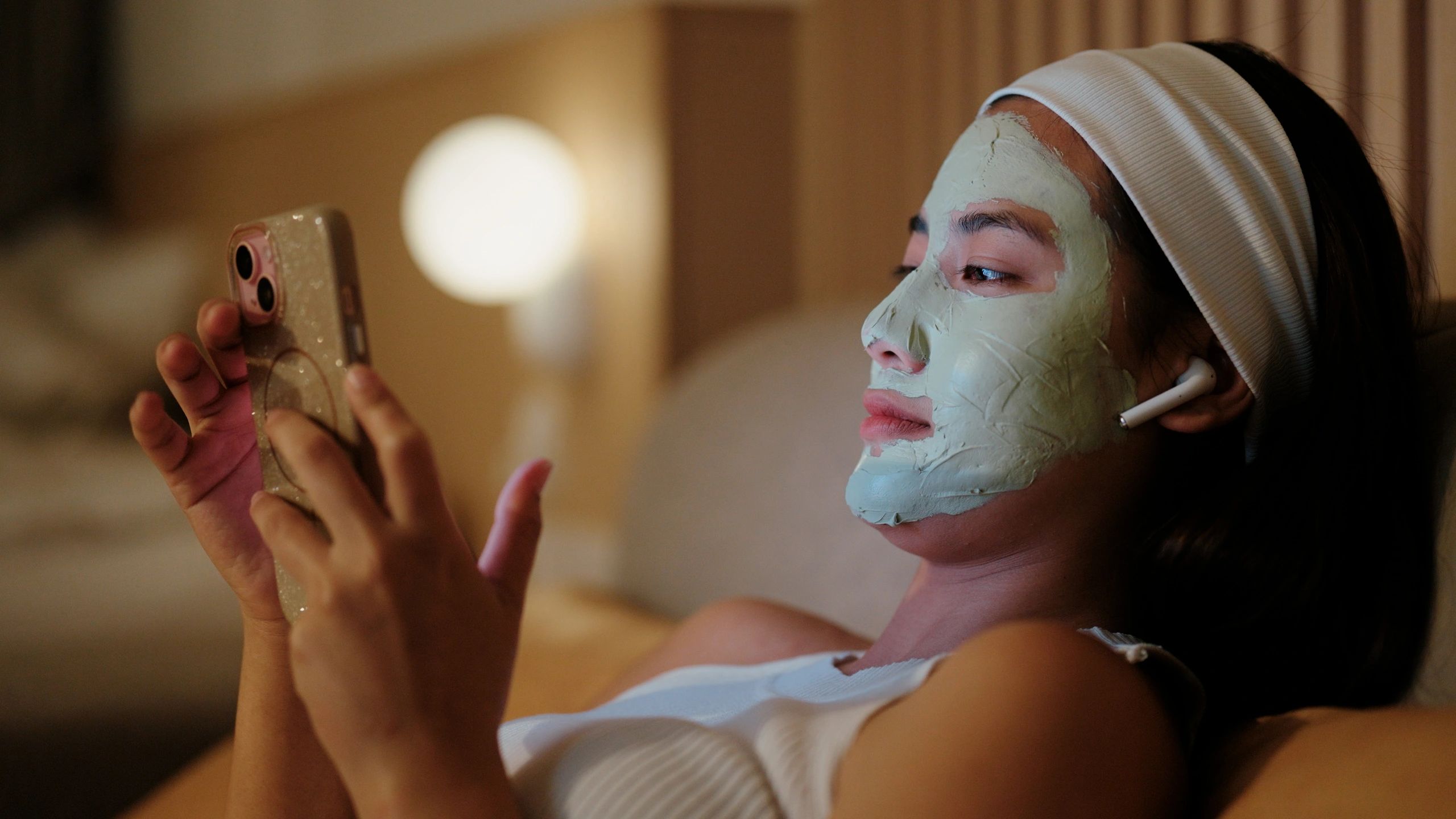 Woman with face mask taking selfie — self-care rituals